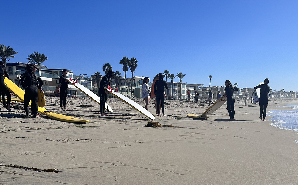 People taking a surfing lesson in Pacific Beach.